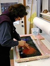 Nancy Current siliconing glass in her studio. Nancy Current siliconing glass in her studio.