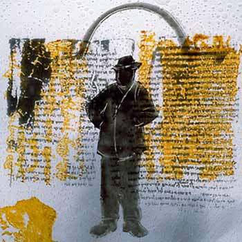 Man standing in front of ancient Jewish text.